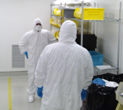 Two certifiers wearing PPE in a cleanroom
